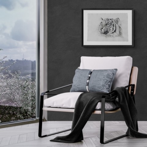 Painting of a tiger drawing in a room setting with an armchair 