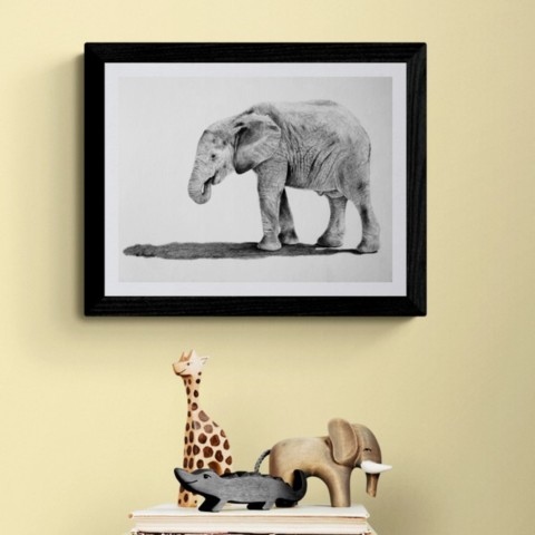 Painting of a baby elephant drawing in a setting with African sculptures bu Laurence Saunois, wildlife artist