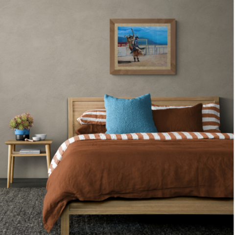 Tableau de bull riding dans une chambre au dessus d'un lit